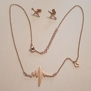 #1009 S Steel, Gold Toned Heart & Heart Beat Pendant Necklace And Earrings.